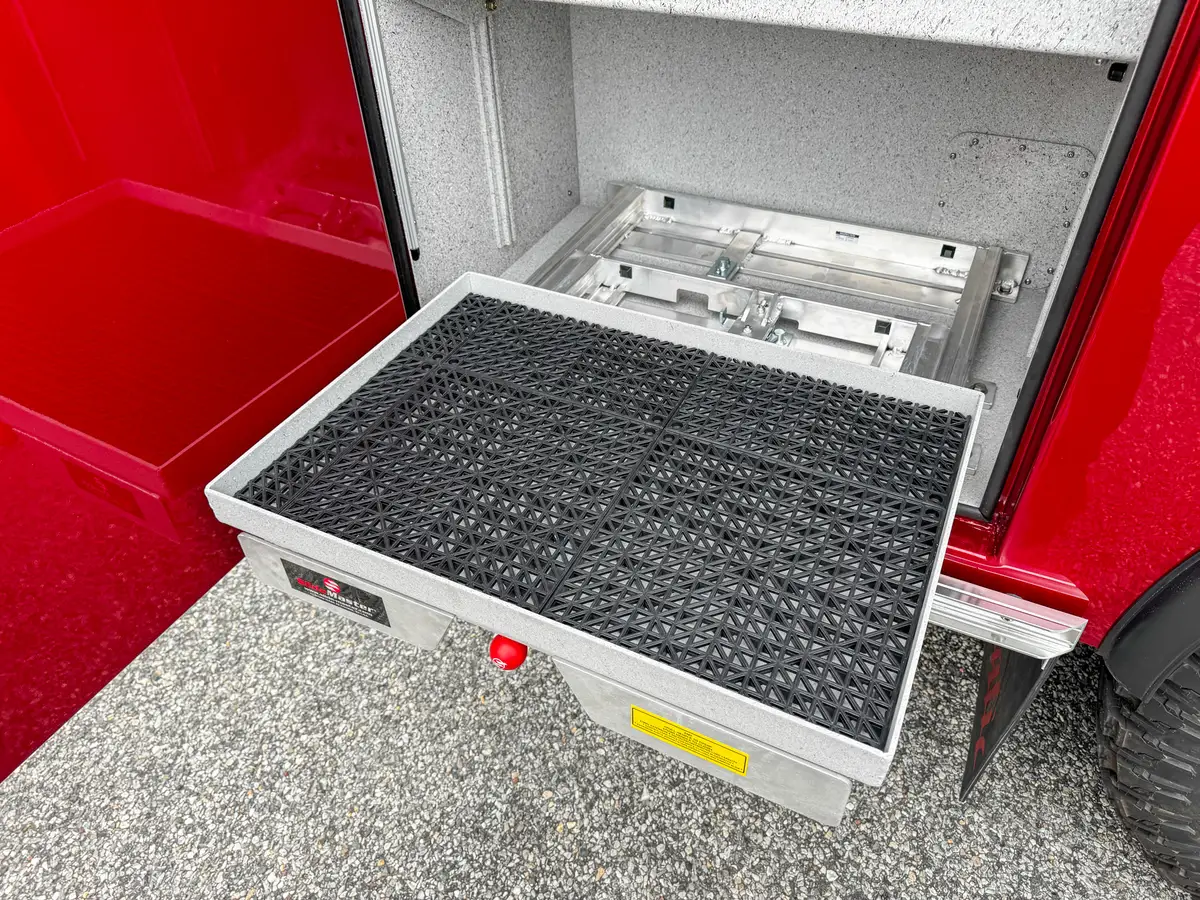 Crew-cab side profile showing front wheel, side body, and pump-panel section.